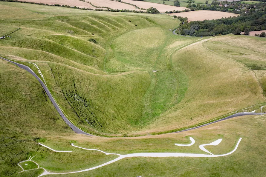 Aerial view of the White Horse and Manger looking north. The chalk downs are in the foreground, with the fields of West Oxfordshire in the background. Image property of Hedley Thorne.  