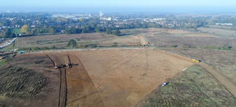 Aerial view of the Gilden Way site with features in the foreground and Harlow in the background