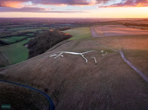The White Horse at sunrise with the light gradually illuminating the chalk figure. With this light, it is easy to imagine the White Horse as galloping in the sky, pulling the sun chariot, as some scholars have hypothesised. Image property of Hedley Thorne.