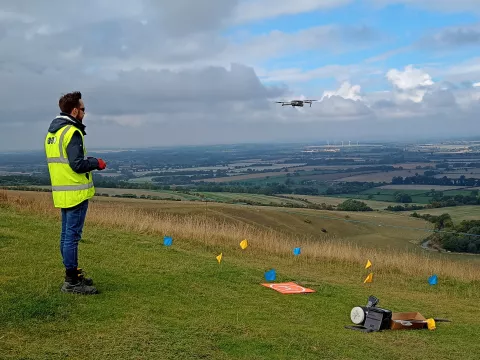 Ben from the OA team flying his drone over the hill to survey the White Horse. 