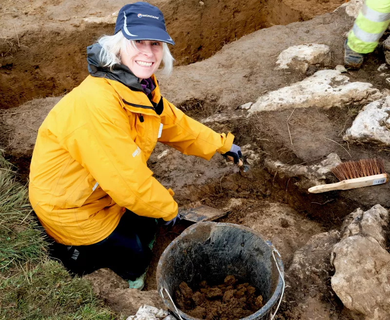 Volunteer excavating a longhouse 