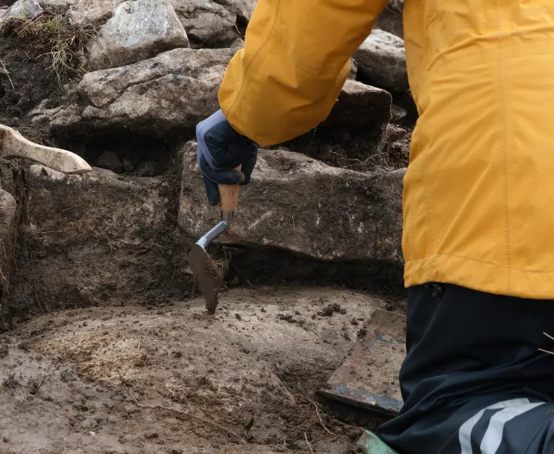 Trowel against medieval longhouse