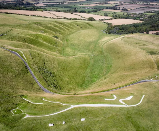 Aerial view of the White Horse and Manger looking north. The chalk downs are in the foreground, with the fields of West Oxfordshire in the background. Image property of Hedley Thorne.  